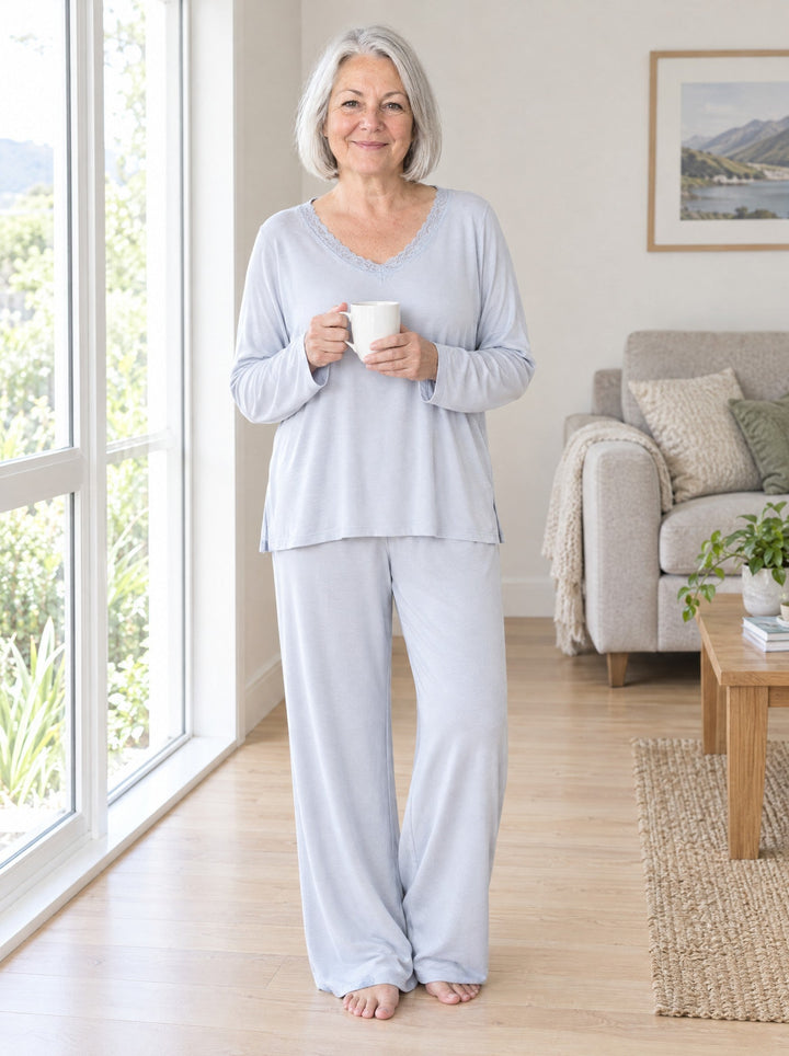 Woman wearing the lace-trim V-neck pyjama set in pale blue